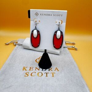 EUC gunmetal Emmy with white MOP and red glass.